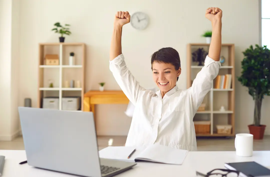 Man looking at the laptop and being joyful of something
